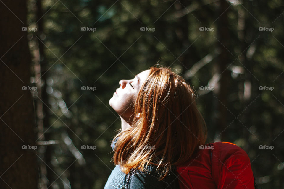 woman enjoying the sun in the forest