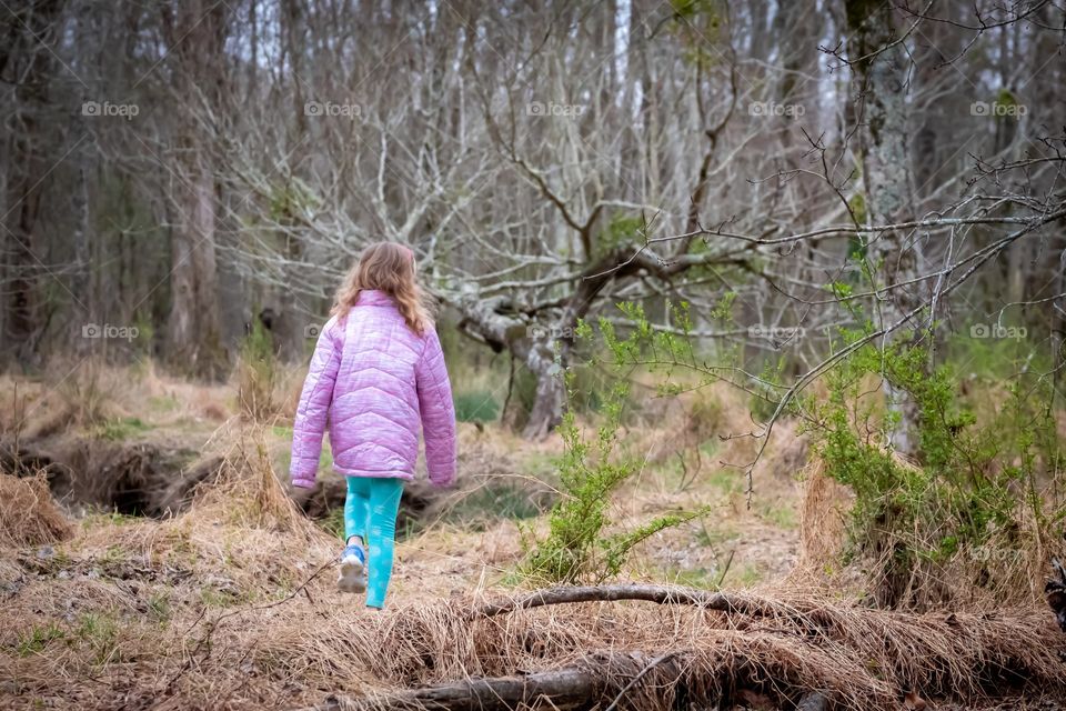 Little girl finding her favorite tree in the forest/swamp. 