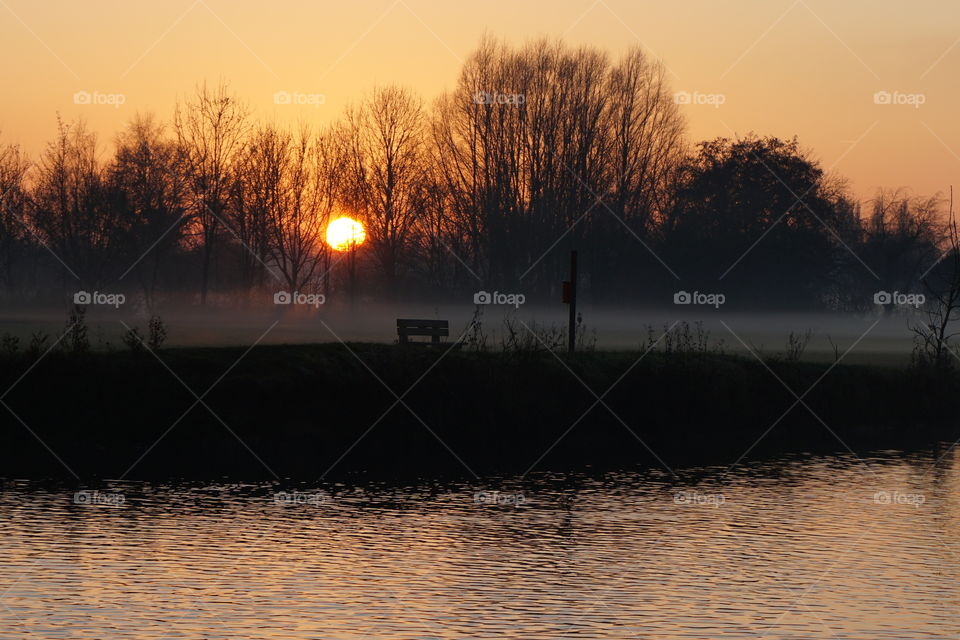 Most unusual sunset .. lt was very cold and a foggy low lying must was hovering about the land and the sun appeared red and very large as it began to set ..