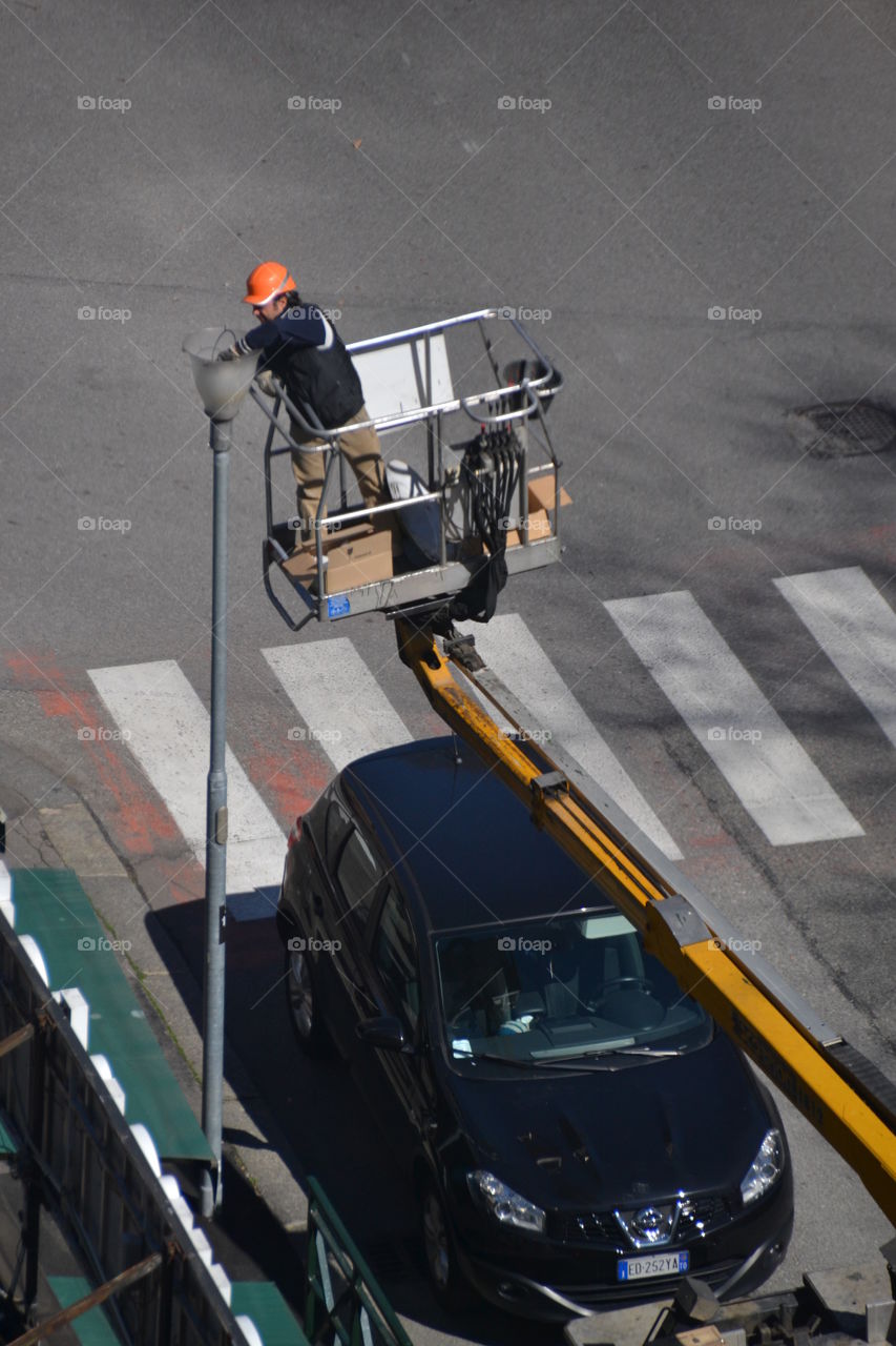 a worker repairing a streetlight