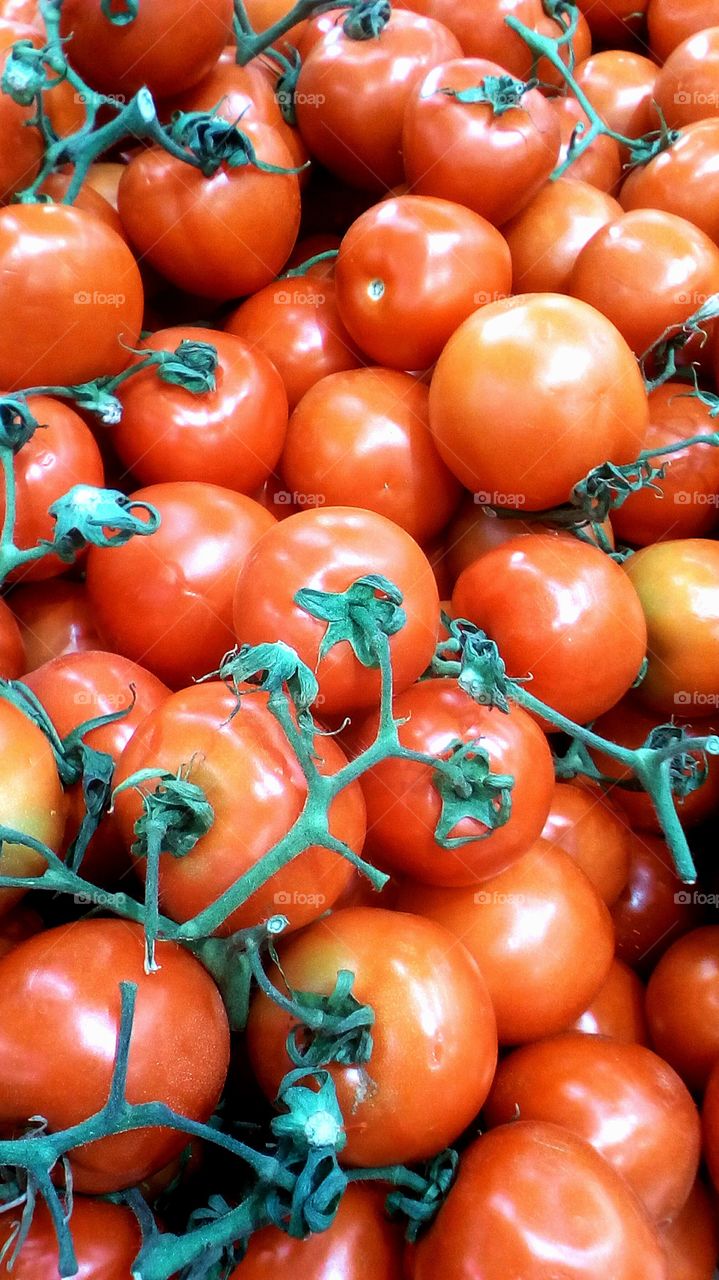 Fresh round bright healthy whole clean
tomatoes in abundence in maket for sale