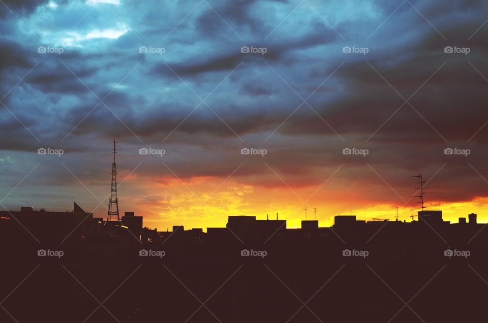 Silhouette of cityscape against sunset sky in Berlin, Germany.