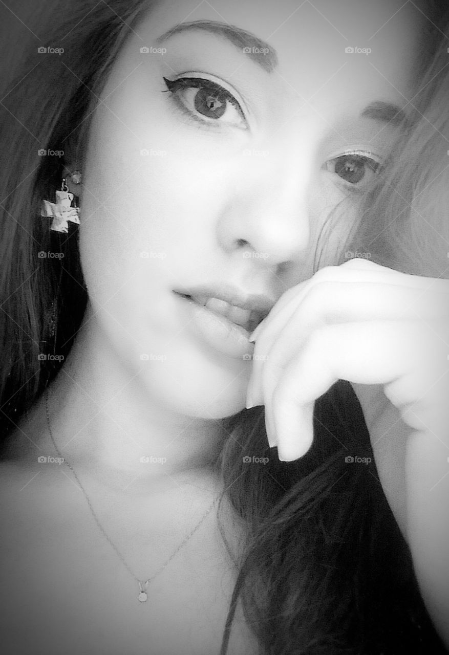 portrait of a beautiful young girl with a dramatic facial expression in grayscale