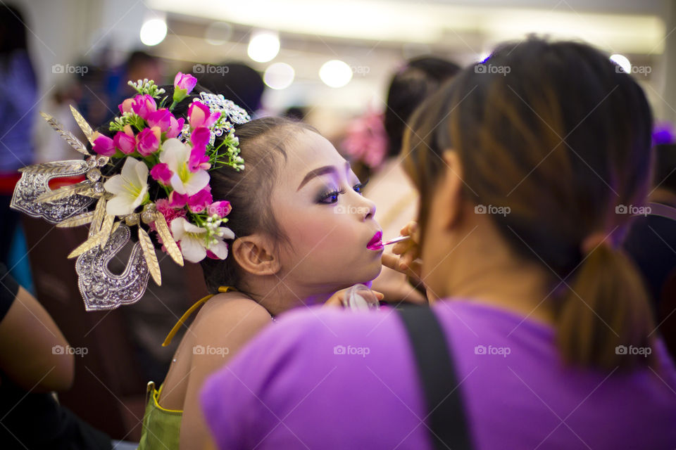 Before the show, young girl artist make up. mother make up her child prior doing a show