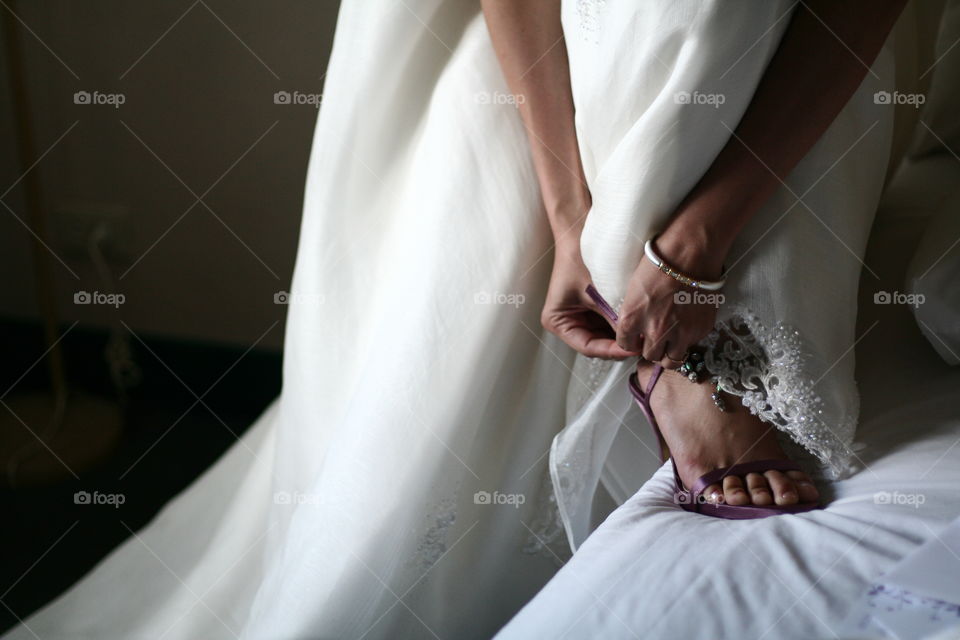 bride wearing her shoe