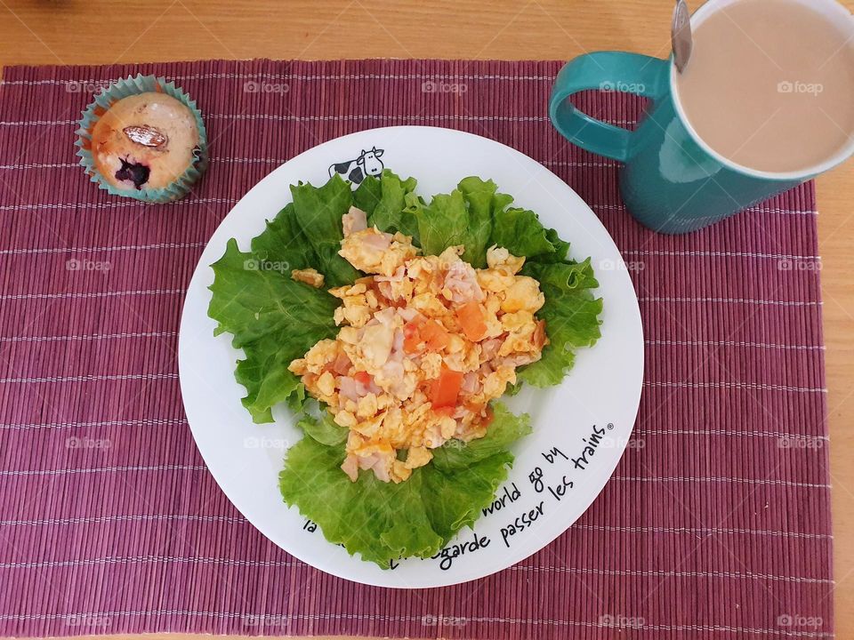 Appetising breakfast with eggs, muffin and coffee.