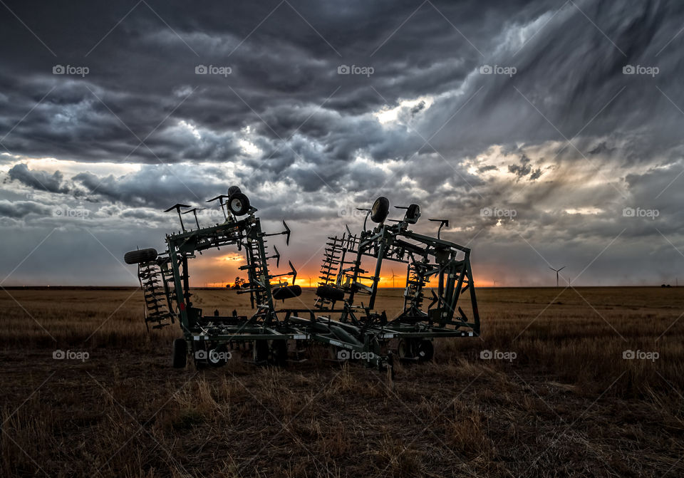 Harrows in a stormy sunset, Kansas