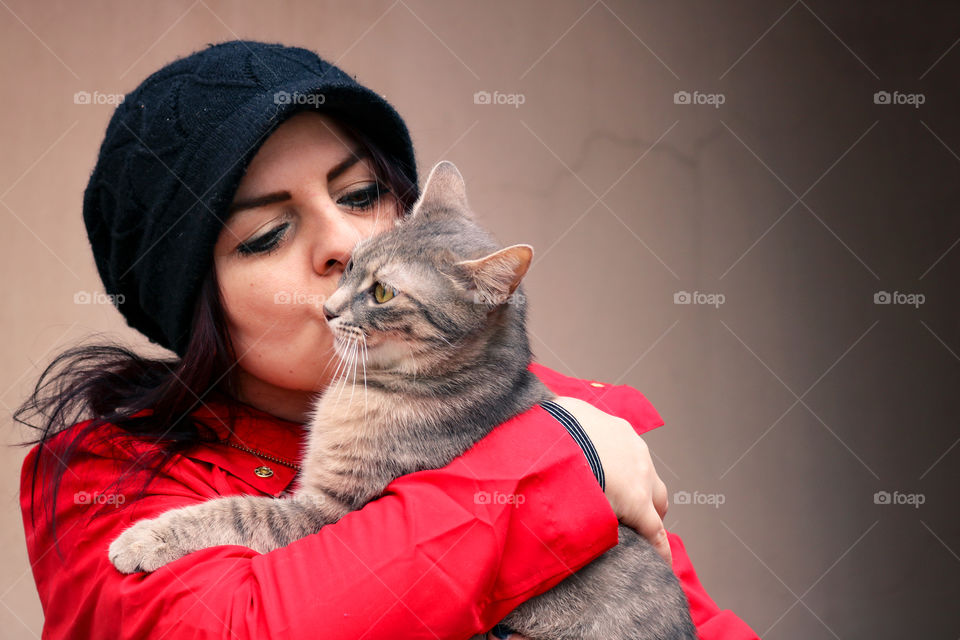 A woman kissing a cat