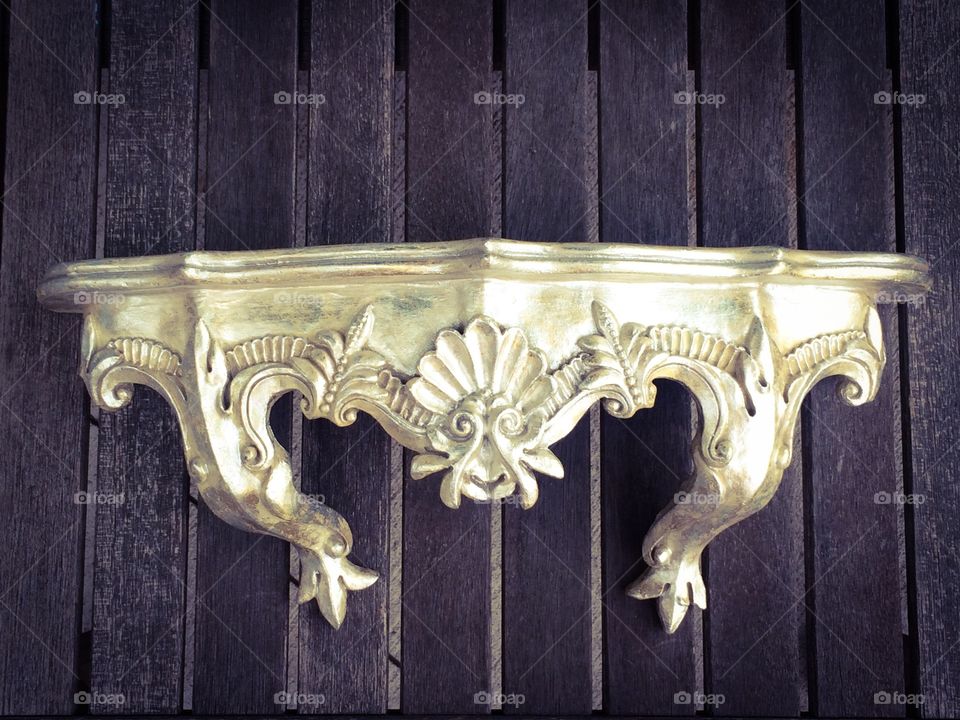 Ornate. A beautiful ornate shelf on a rustic background. 