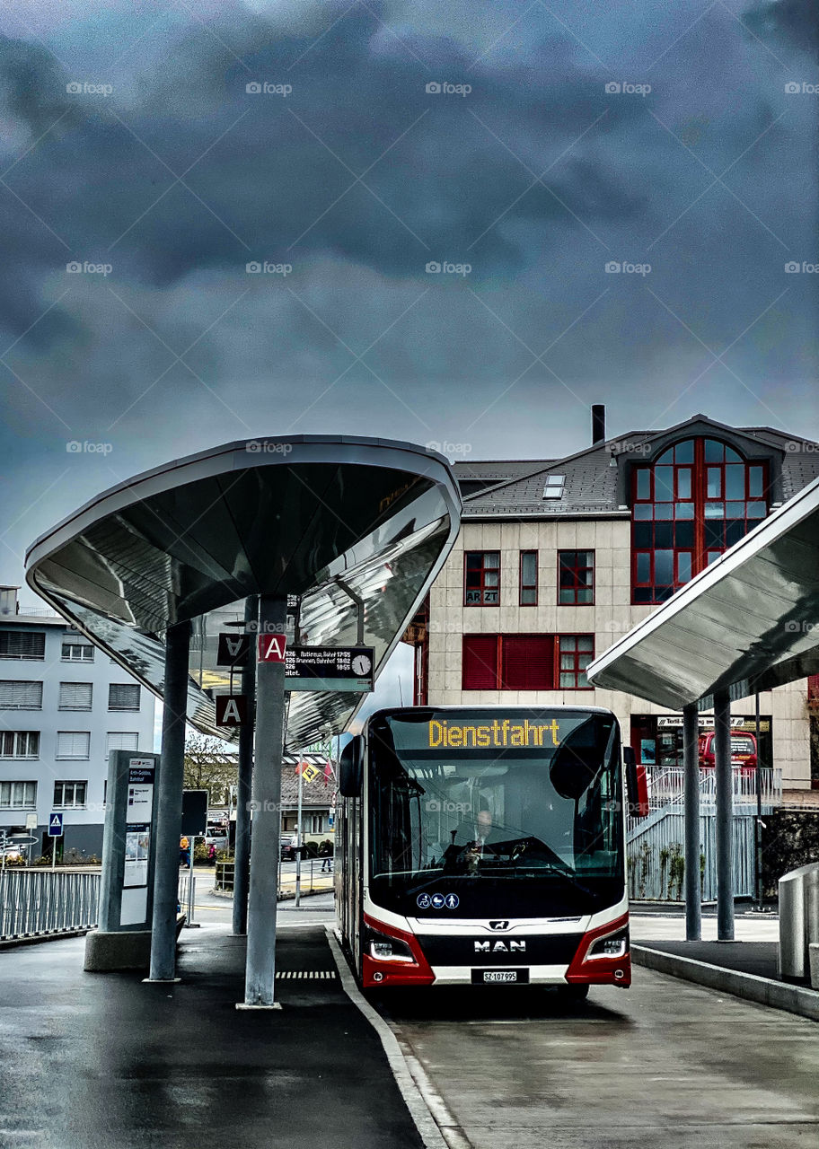 Swiss beauties, Swiss mountains, clouds floating over the Alps, railway, stop, bus, beautiful painted building, road