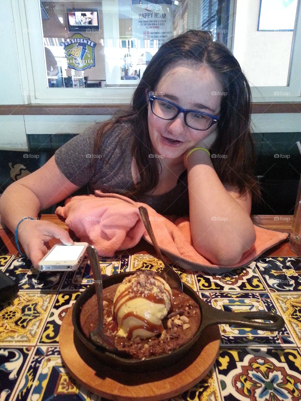 Woman looking at baked pudding with ice-cream