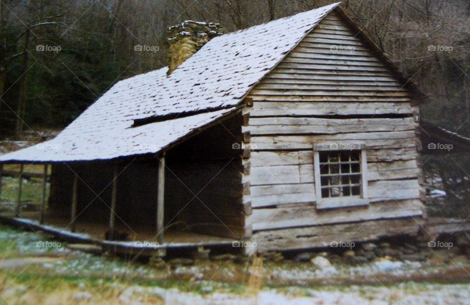 Log cabin snow on roof