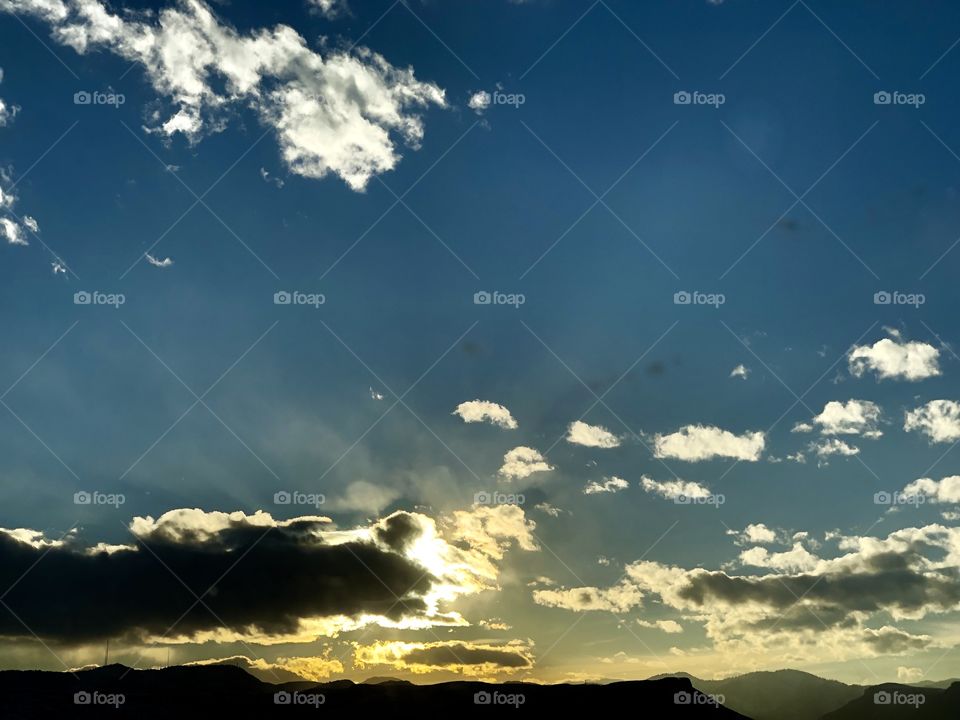 Brilliant Sunset over the dark Rocky Mountain range.