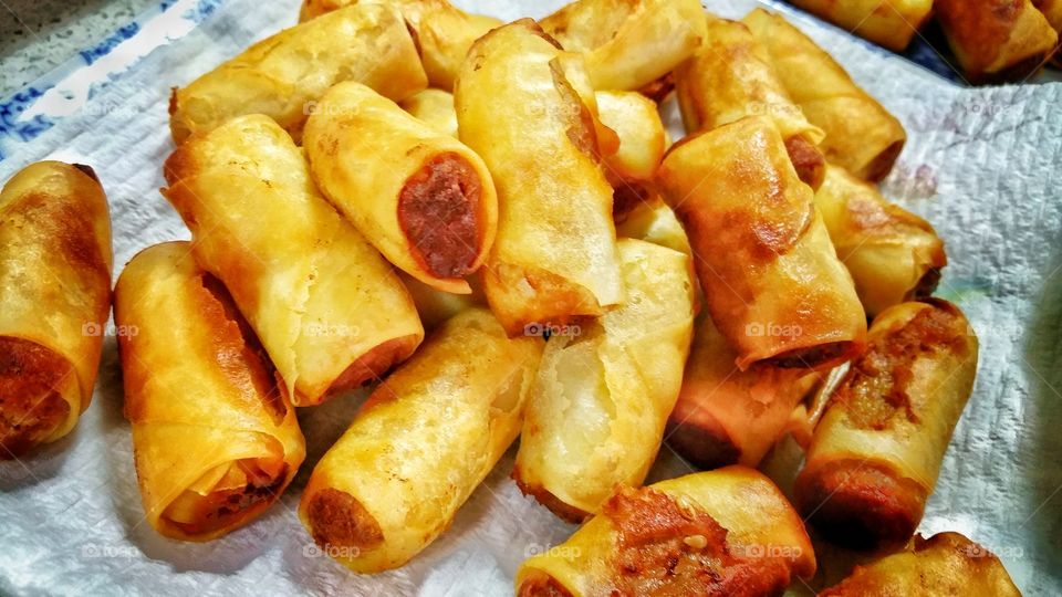 Homemade Chinese mini spring rolls - pastry usually filled with a combination of vegetables and meat before deep frying till golden brown in color. The finished rolls are allowed to rest a little prior to consumption.