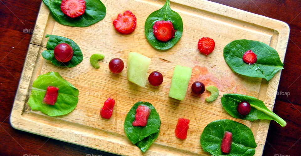 diagonal flay lay of red fruits and greens