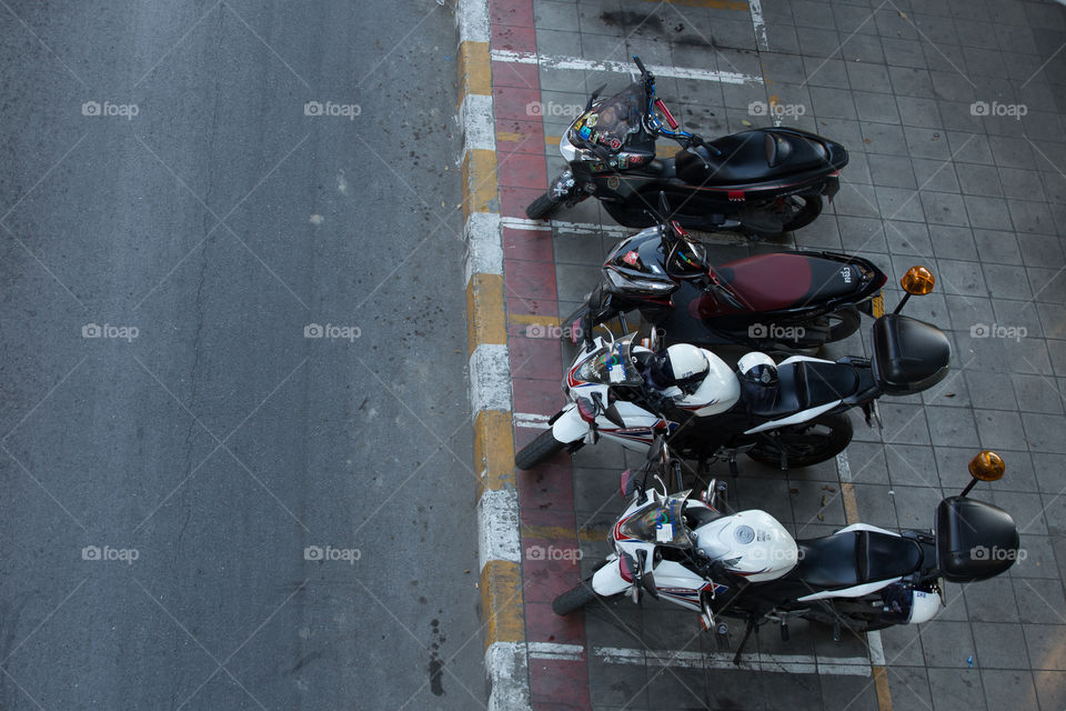 Motorcycle park in the sidewalk 