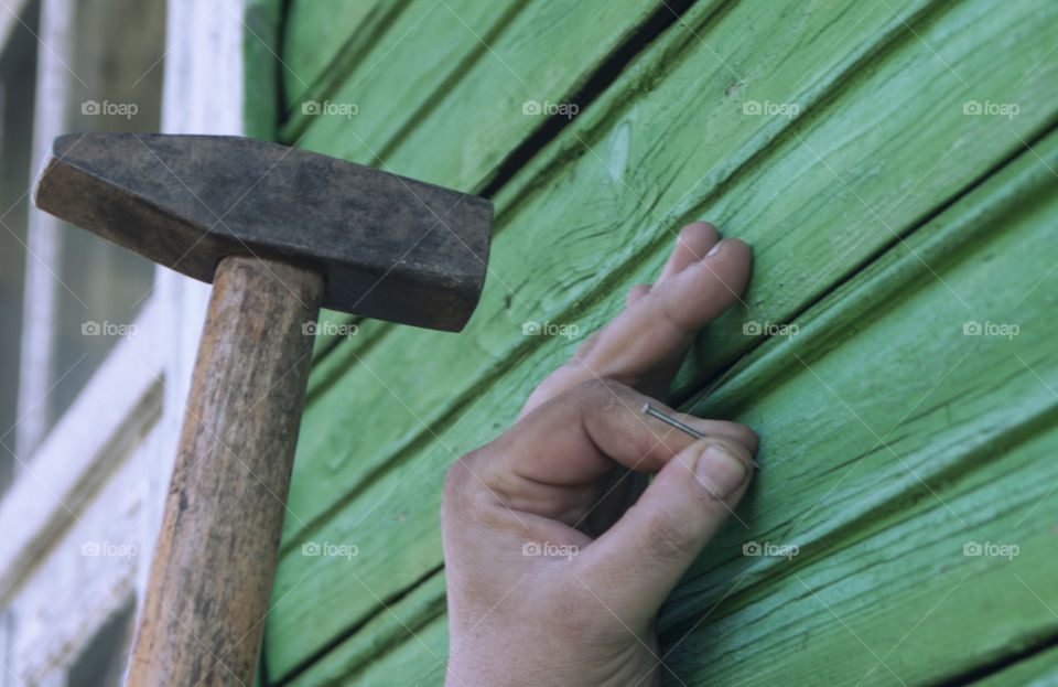 A man is hammering a nail