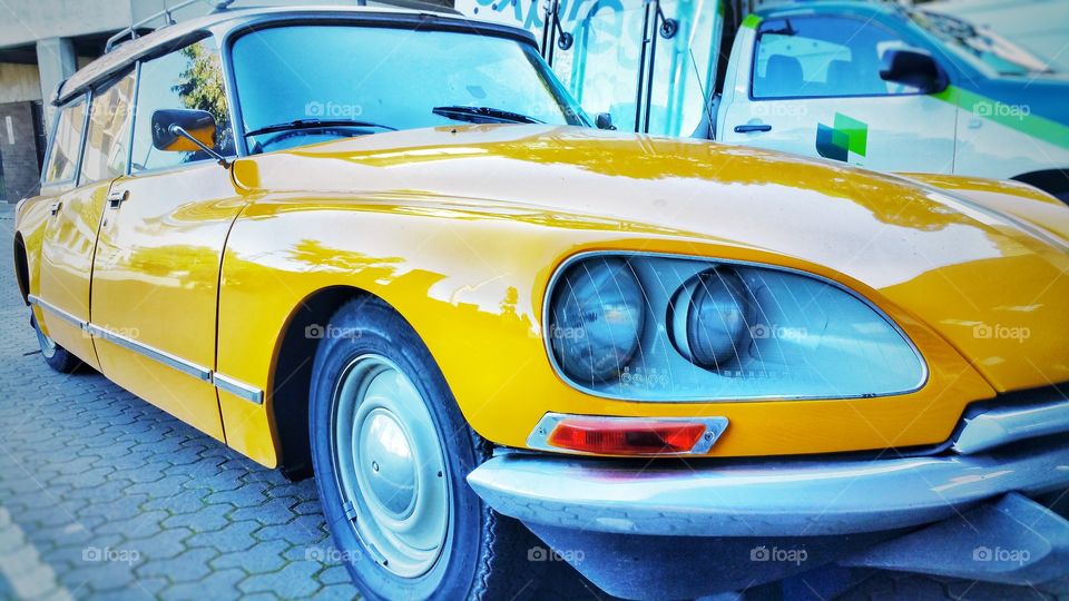 The Citroën DS is a front-engine, front-wheel-drive executive car made in France. It's design resembles that of a platypus and has a cult following. This yellow specimen is a rare station wagon variant.