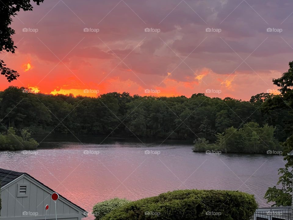 I shot this peaceful lakefront sunset scene on my iPhone during the summer, in Blackstone, MA, overlooking the water of the Blackstone River/Harris Pond.