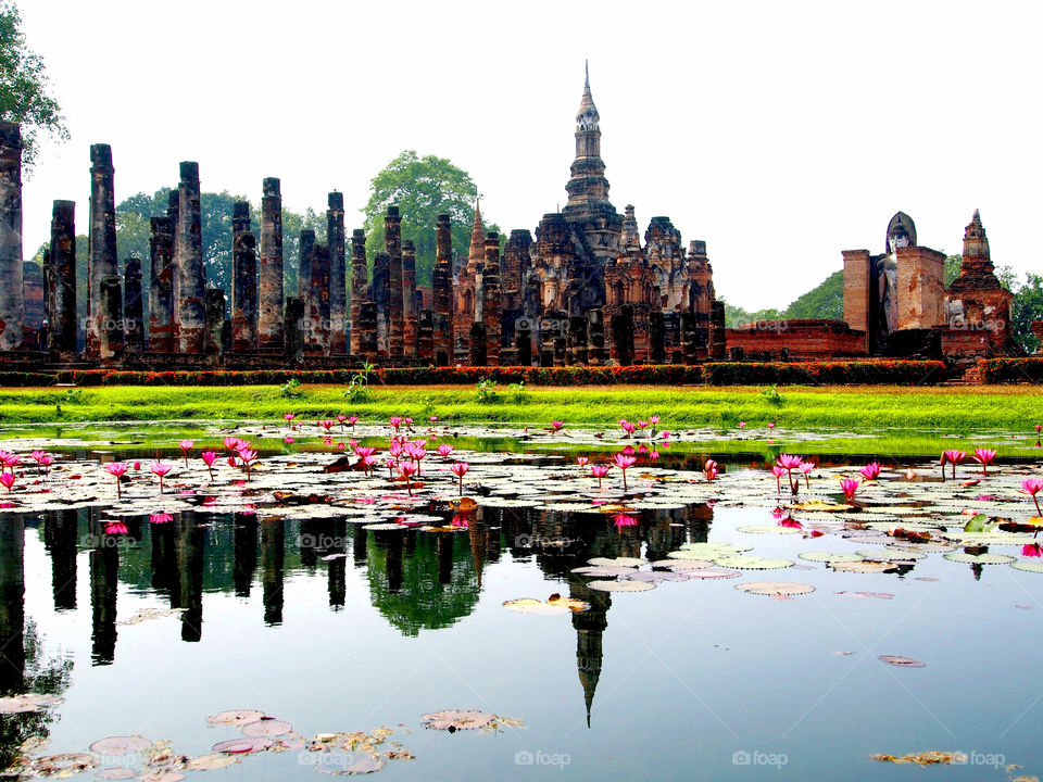Historical park at Sukhothai,Thailand with lake reflection