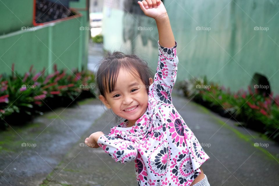 Sweet smile from a playful child. A contagious smile that ligthens everyone’s heart.lnsi geniune and so pure