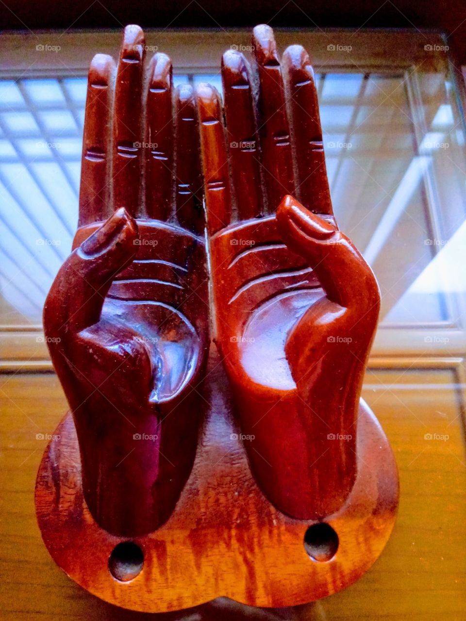 A shape of two wooden hands with the reflection of lines and square from the window,   in Yangsan South Korea