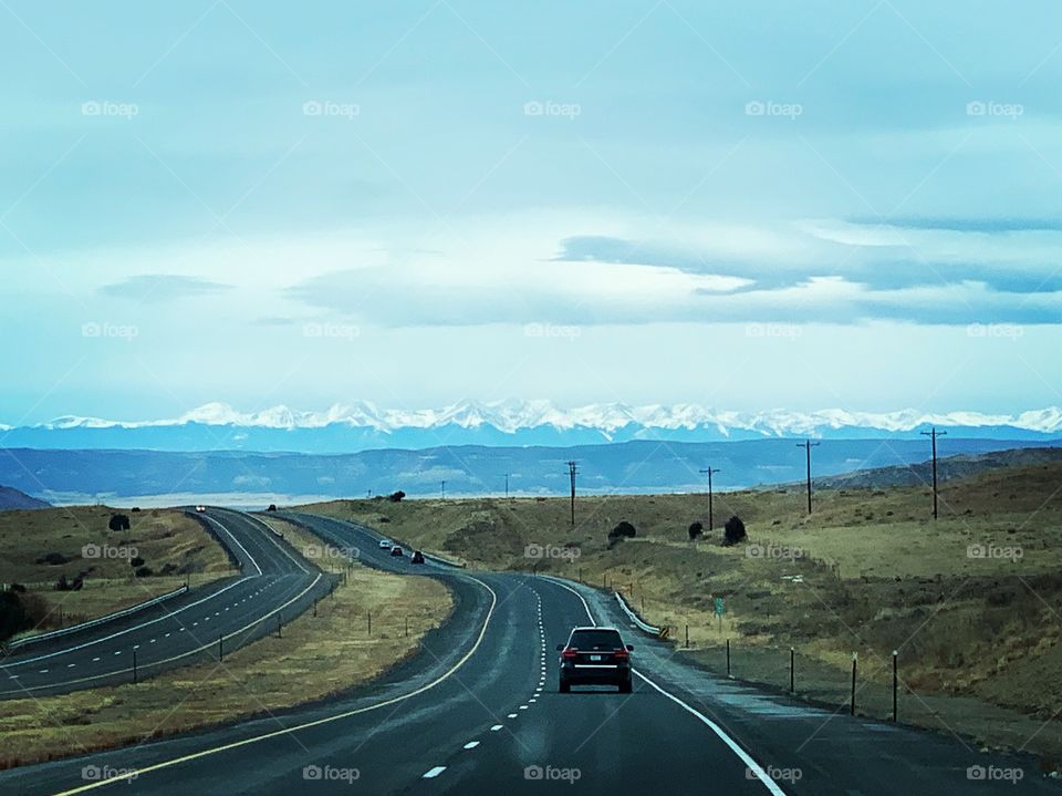 Taking a road trip and traveling the world and enjoying the scenic views of the beautiful snow-capped mountains of Colorado. 