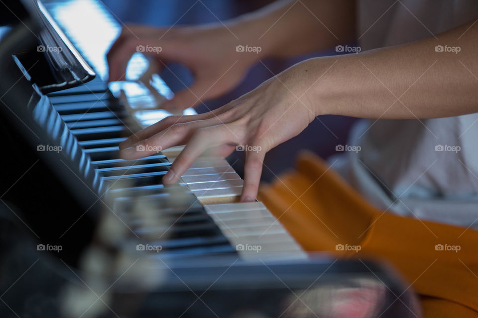 Close-up of a person playing piano