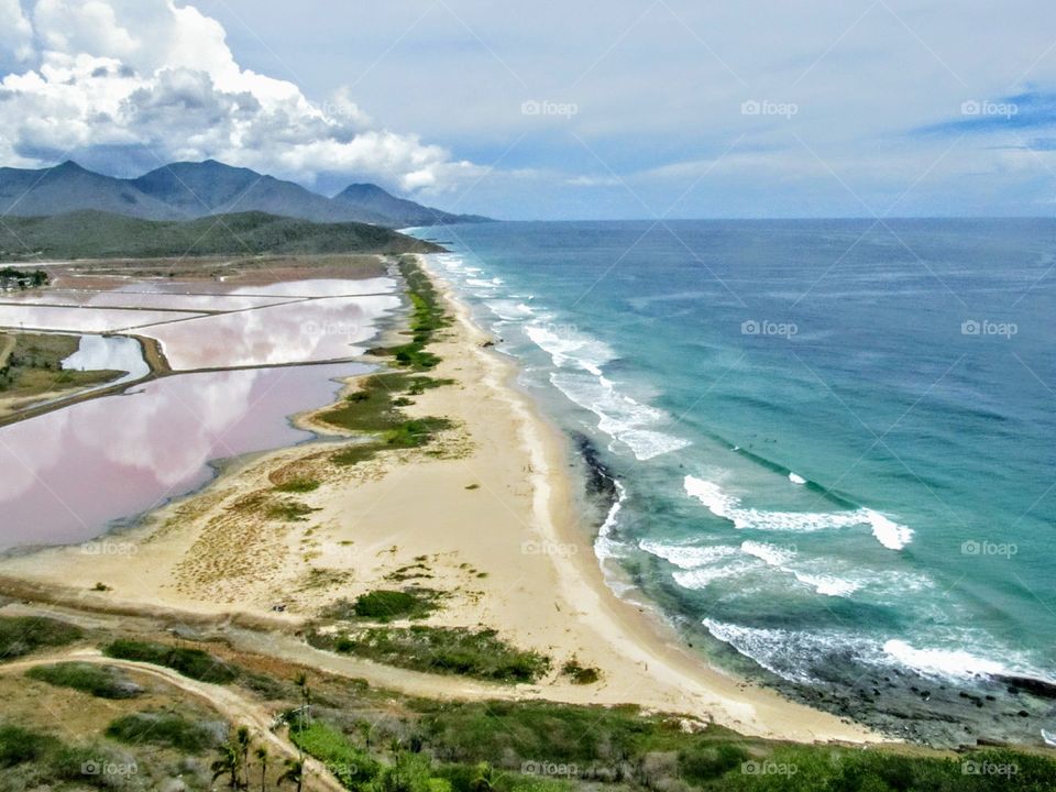 a beautiful beach combine a purple salt lagoon
