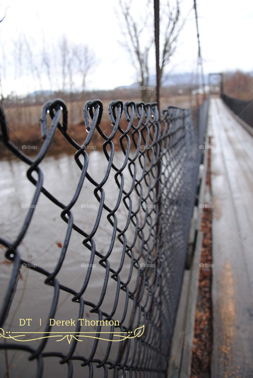 fence protecting riders from the rivers edge.