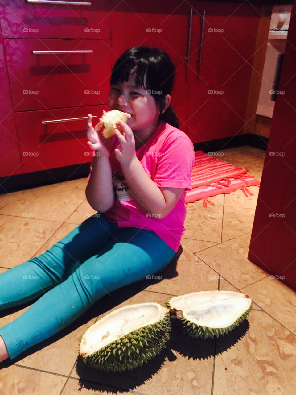 kid and the fruit king. preschooler eating durian king of fruits.tropical fruit