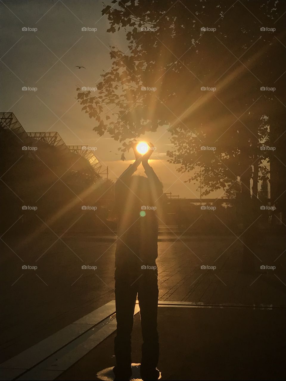 Little girl has captured the sun in her hands