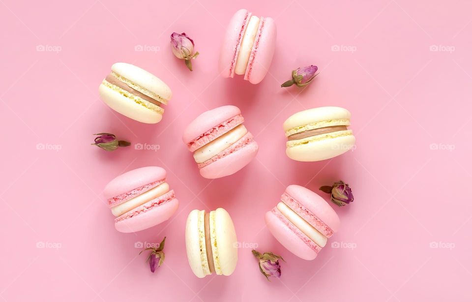 macarons on pastel pink background