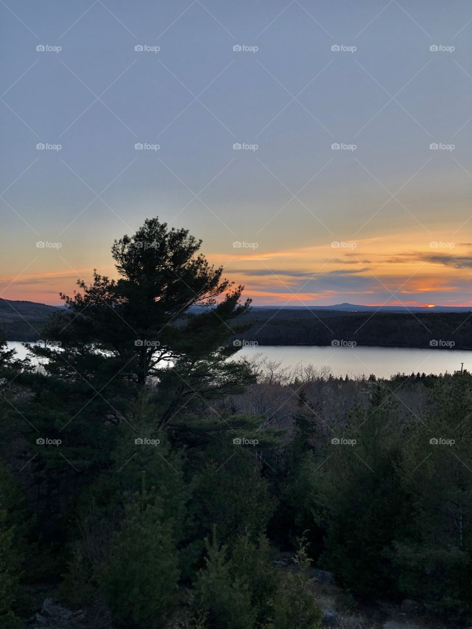 Colorful sunset over mountains and Eagle Lake in Acadia National Park in Bar Harbor, Maine USA during Spring season