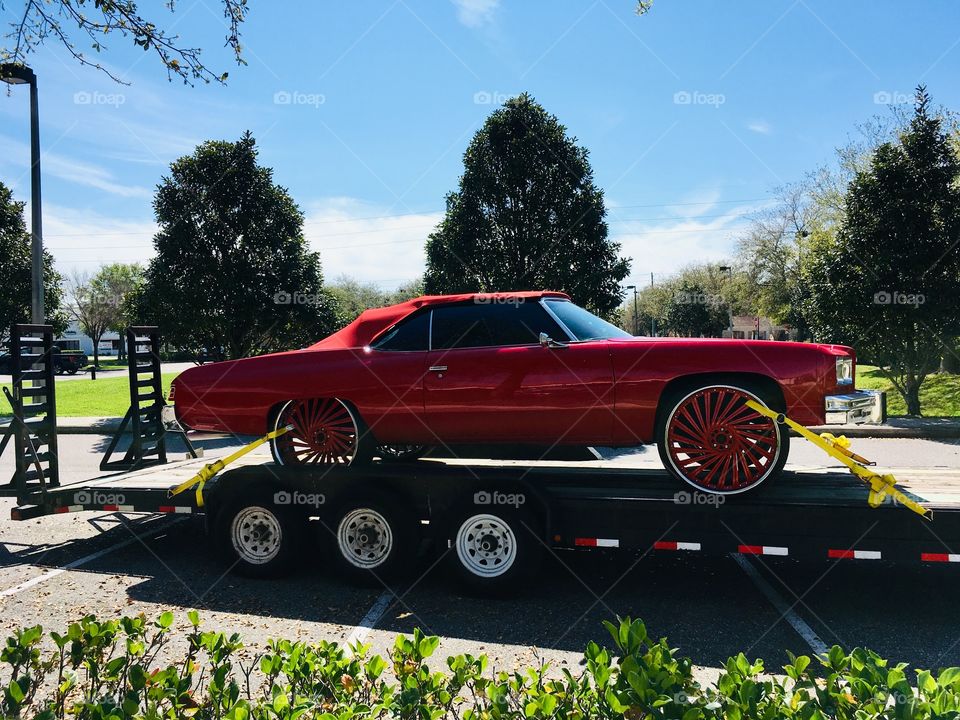 Red ragtop on a trailer 