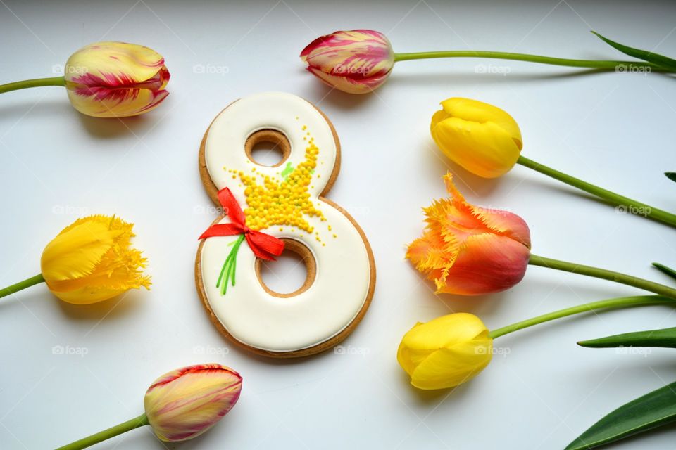 8 March gingerbread and colorful tulips on a white background women's day