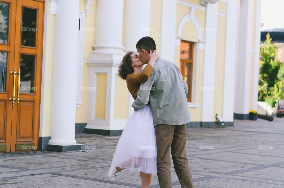 Love story of stylish funny couple. People walking, dancing and kissing in the autumn city. Wedding celebration and date concept.