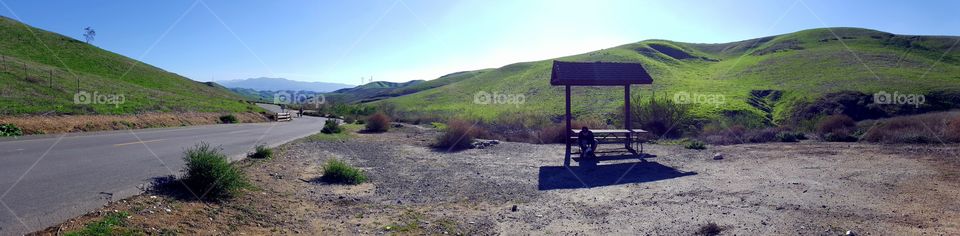 Panoramic view, rest area, hiking trail, man and dog resting from hike