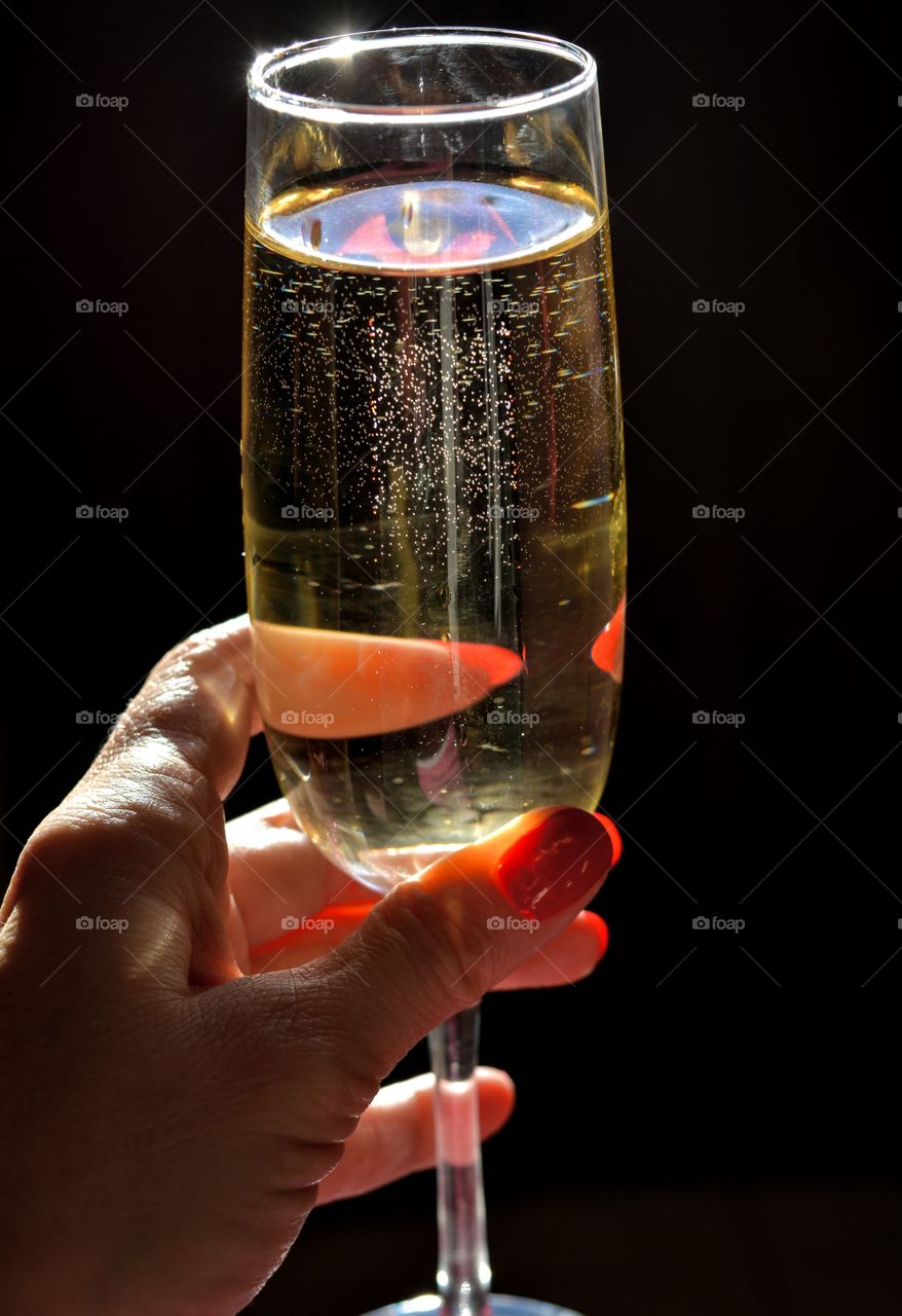 wine glass in the female hand in the sunlight time to relax