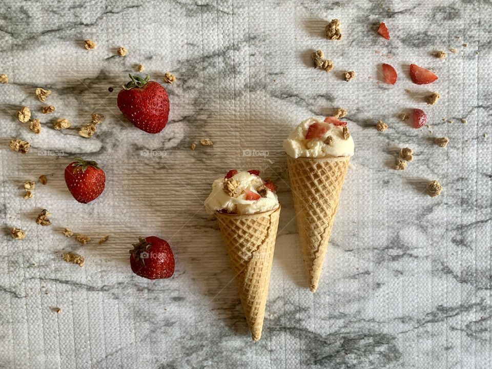 Vanilla ice cream cones with strawberries and granola toppings yummy summer treats 