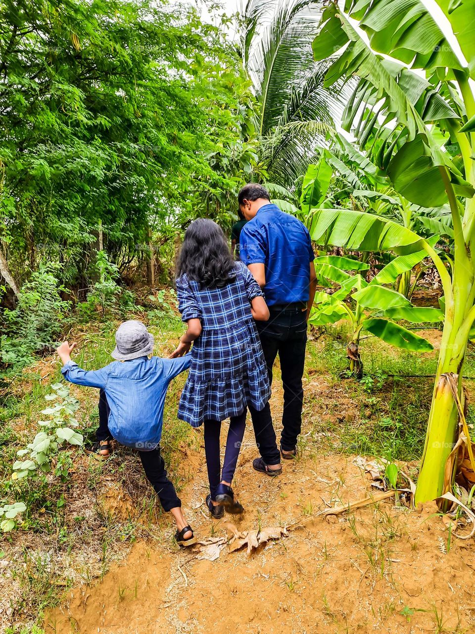 Father taking care of his children while going for a walk