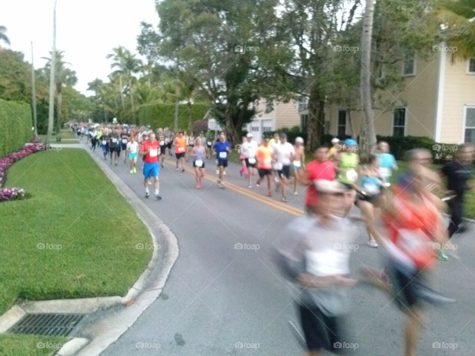 Marathon. Runners pass by during a half marathon in Florida