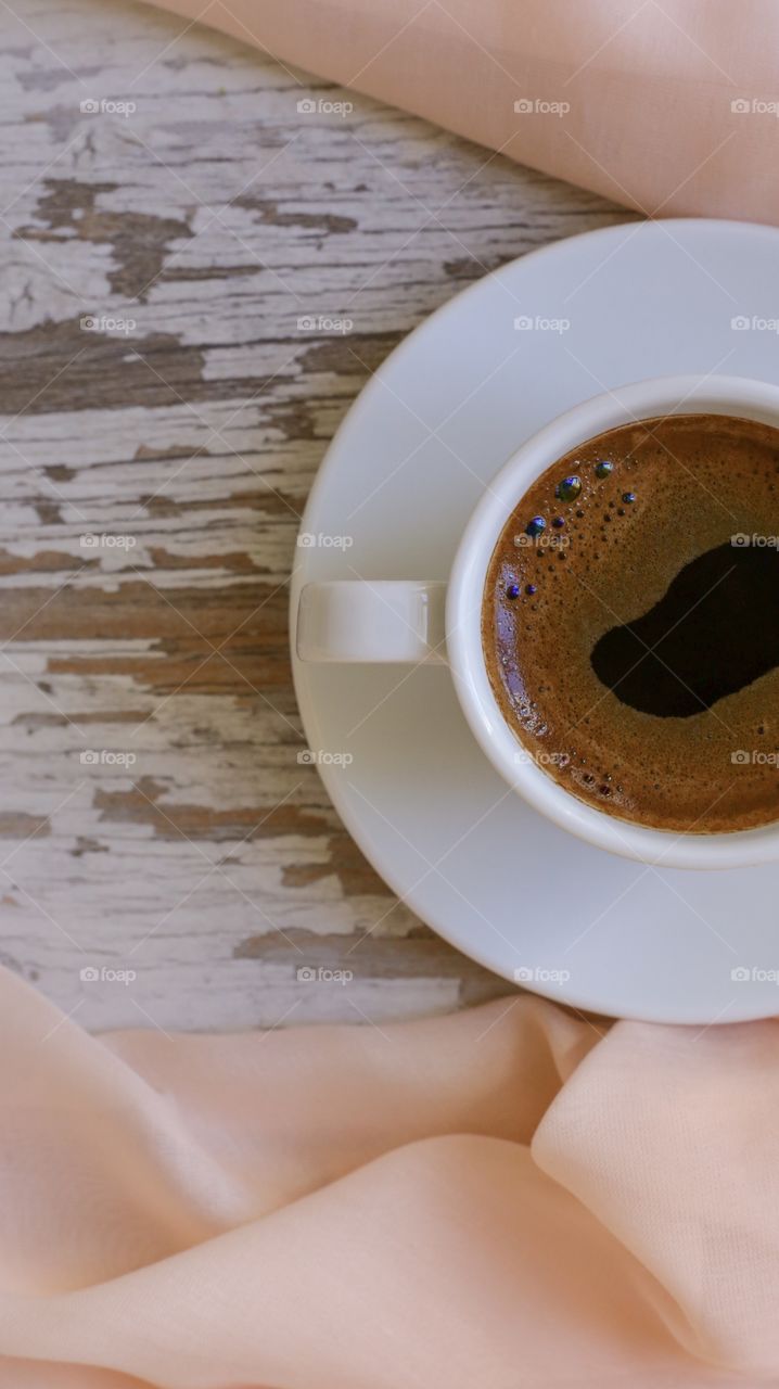 four mugs of coffee and beige cloth