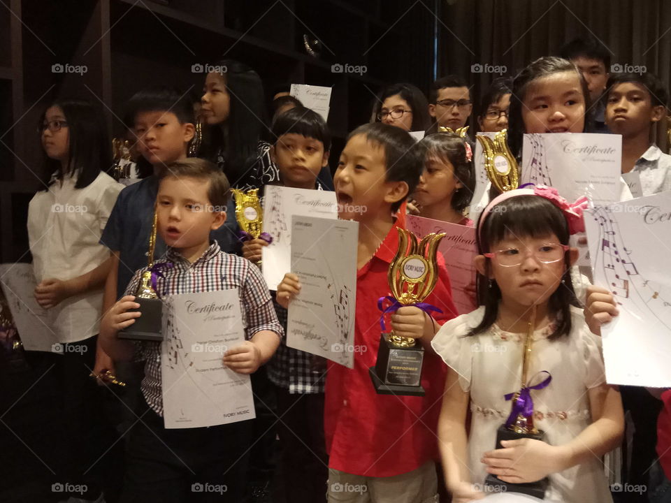 Children receiving awards for playing music