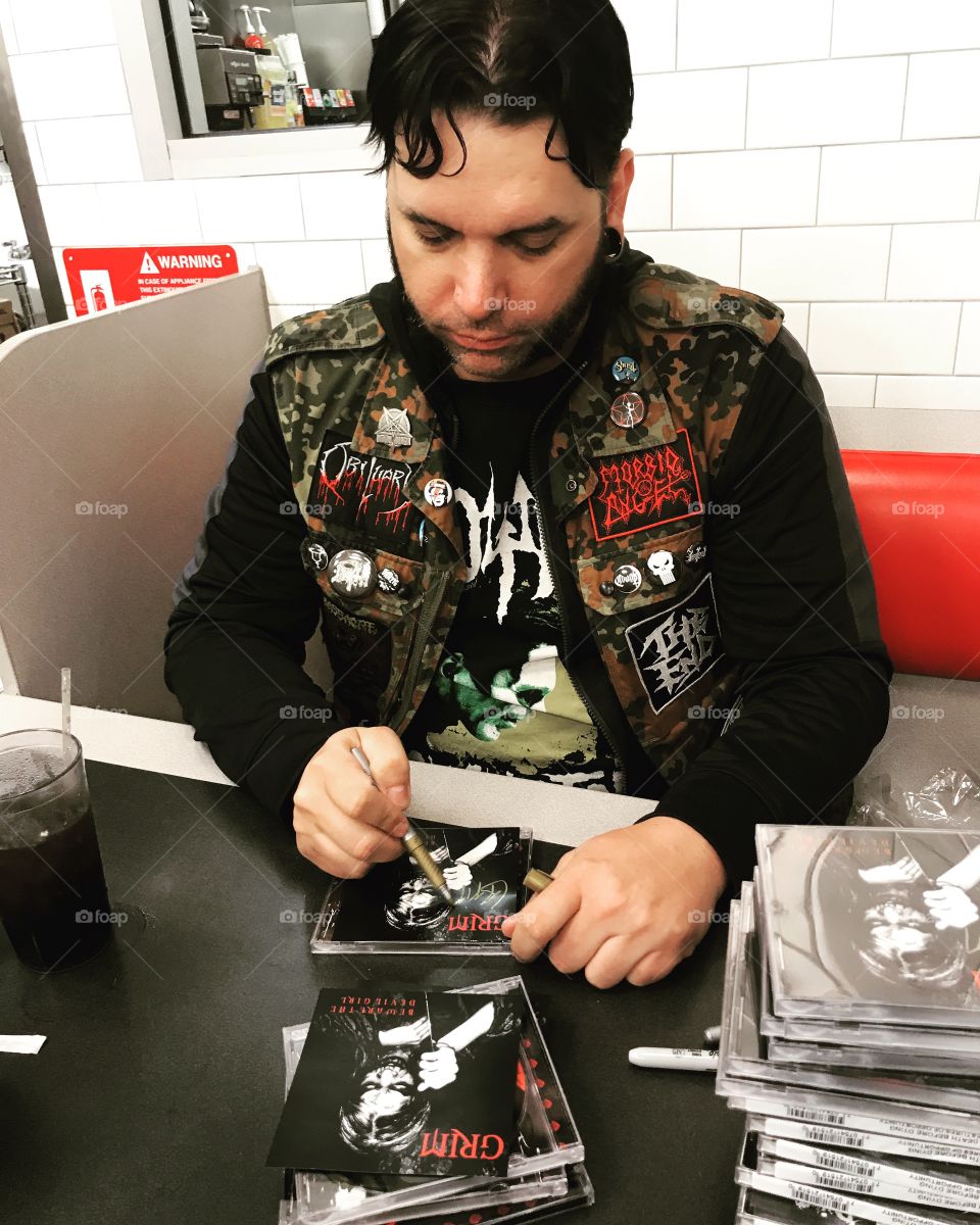 Michael Grim signing his CDs for Sleepless Beast Records