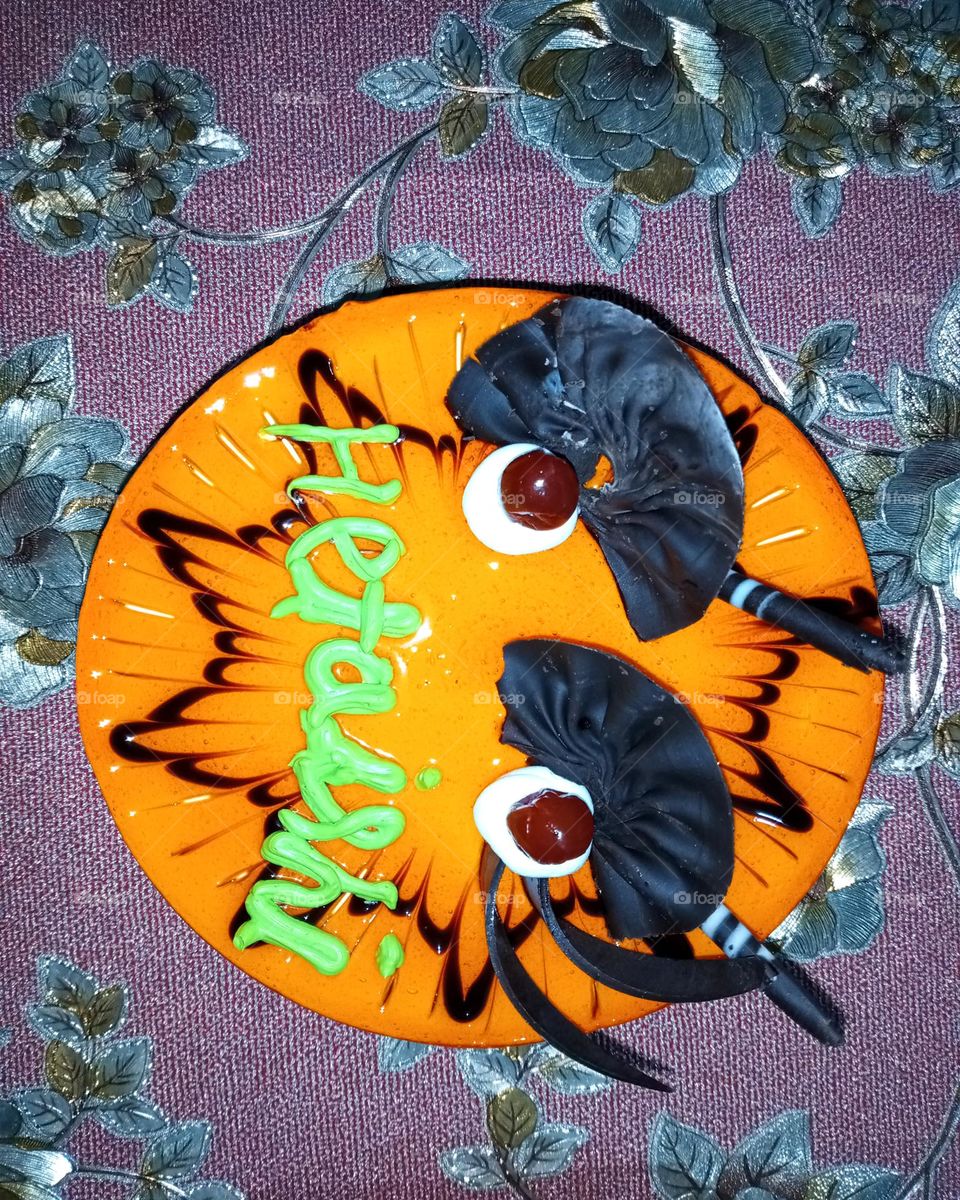 Orange cake.its a birthday cake so nice orange cream use on top and also black colour toppings it's a little princess birthday cake so delicious