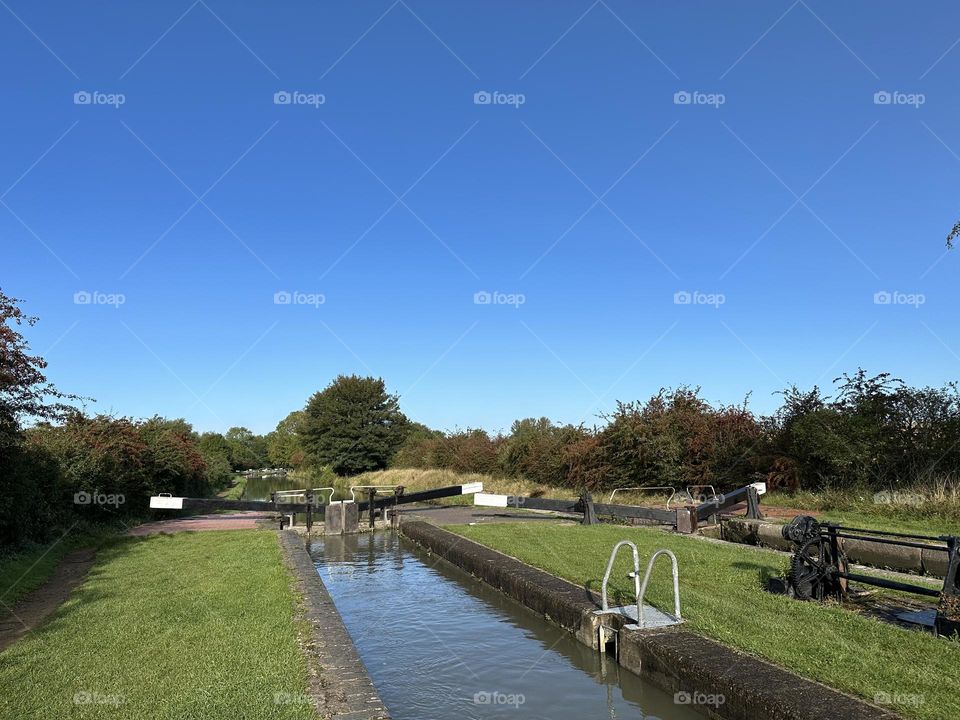 Hillmorton locks near Rugby Oxford canal England narrowboat cruise holiday vacation historic waterway gorgeous clear sky late summer weather