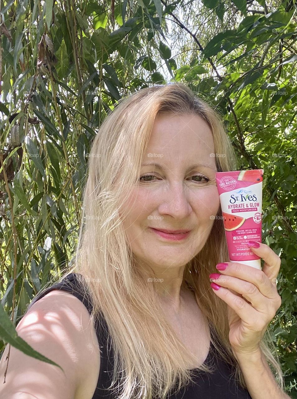 Woman with blonde hair holding a product