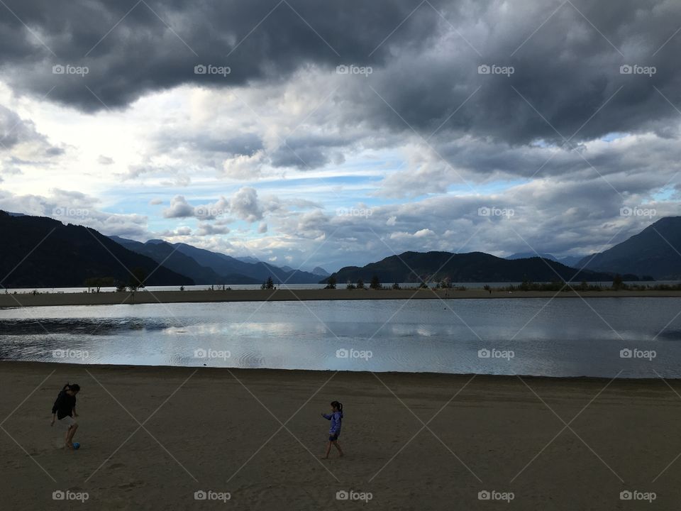 Mother and daughter playing on beach