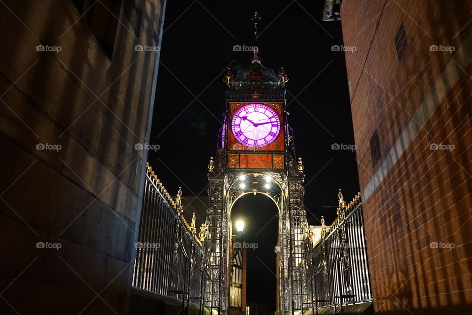 Chester Clock at night .. illuminated in a magenta glow .. beautiful town clock positioned on top of the cities wall 💗💜